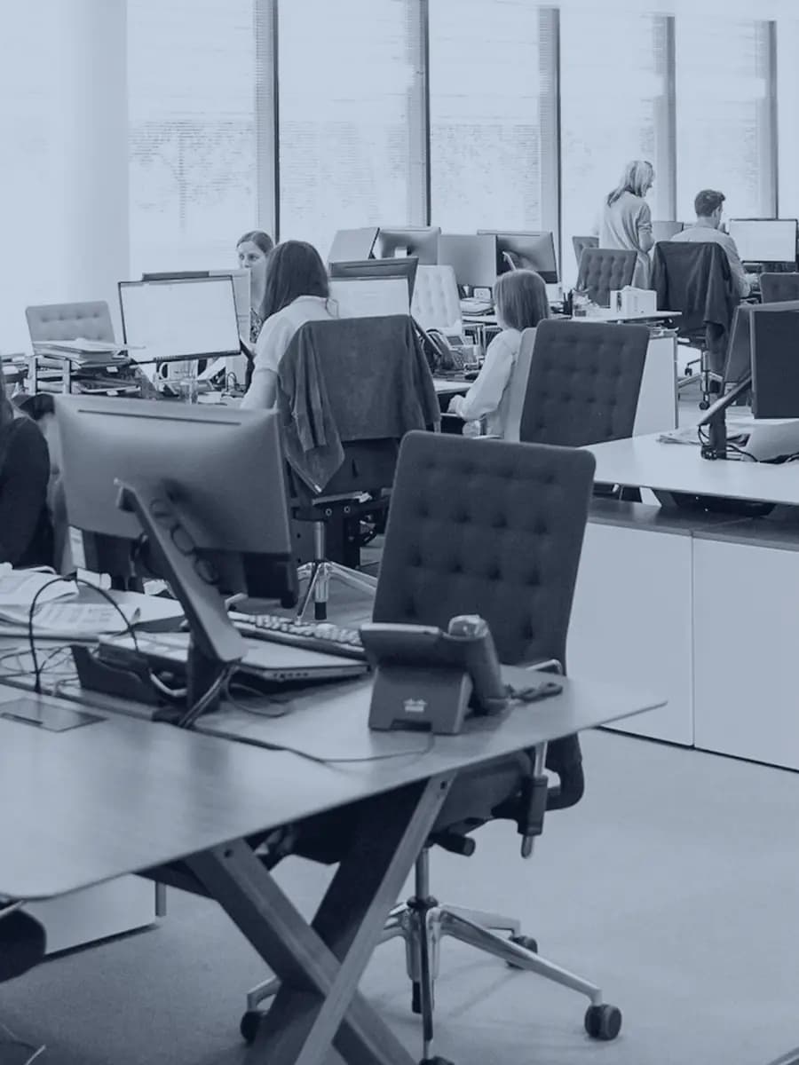 An open plan office with people working at desks