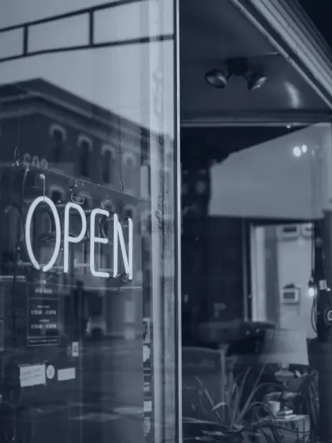 An illuminated open sign in a shop window