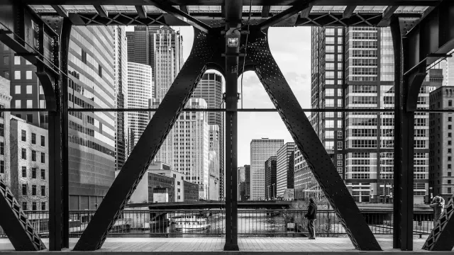 The Chicago skyline framed by the ironwork of a river bridge
