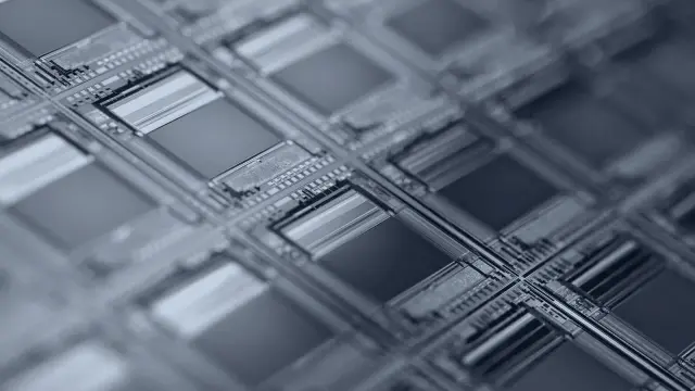 A silicon wafer showing a grid of microchip dies in close-up