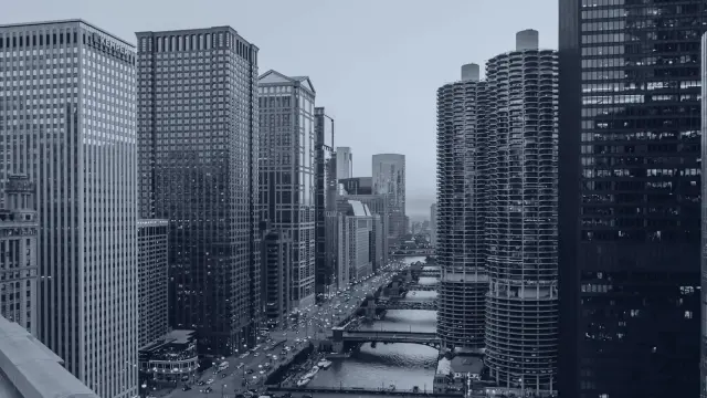 The Chicago river running between high rise buildings at dusk