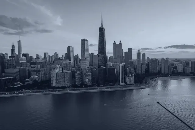 The Chicago lakefront and skyline at dusk, seen from the air